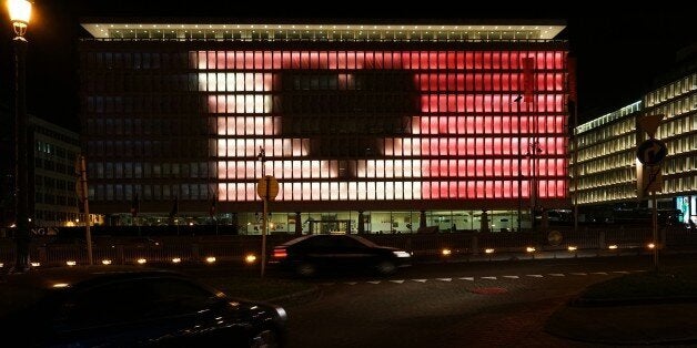 TOPSHOT - A picture taken on March 24, 2016 on place de la Bourse in Brussels, shows a building illuminated with the Belgian