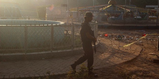 LAHORE, PAKISTAN - MARCH 28: Pakistani commando stand guard at the suicide blast site in Lahore on March 28, 2016. At least 70 people, mostly women and children, have been killed at a crowded park in Pakistan in a suicide blast that also wounded more than 300 people. (Photo by Rana Irfan Ali /Anadolu Agency/Getty Images)