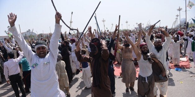 Pakistani supporters of convicted murderer Mumtaz Qadri shout slogans during an anti-government protest in front of the parliament building in Islamabad on March 30, 2016.Islamist protesters gathered in the Pakistani capital said they would not end their days-long sit-in and were 'willing to die', as armed security forces readied to clear the camp. The demonstrators, supporters of executed Islamist assassin Mumtaz Qadri, who was hung on February 29, say they have submitted a list of demands including the execution of a female Christian blasphemy convict.Pakistan's army launched raids and arrested suspects after a Taliban suicide bomber targeting Christians over Easter killed 72 people including many children in a park crowded with families. / AFP / AAMIR QURESHI (Photo credit should read AAMIR QURESHI/AFP/Getty Images)