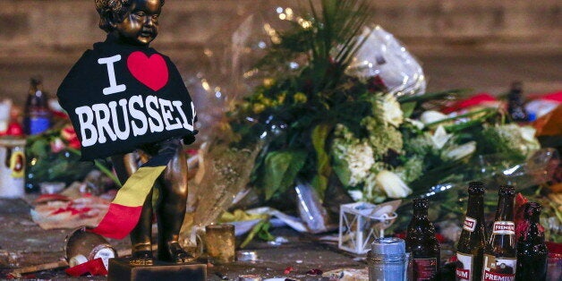 A replica of the Manneken-Pis statue, a major Brussels tourist attraction, is seen among flowers at a memorial for the victim