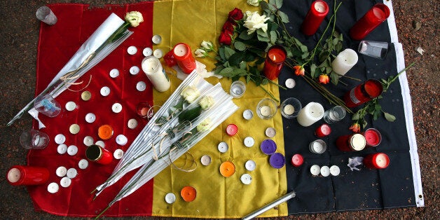 BRUSSELS, BELGIUM - MARCH 24: Flowers are left with a Belgian flag near Brussels airport on March 24, 2016 in Brussels, Belgi