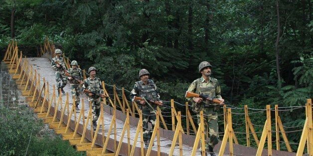 Indian Border Security Force (BSF) soldiers patrol over a footbridge near the Line of Control (LoC), a ceasefire line dividing Kashmir between India and Pakistan, at Sabjiyan sector of Poonch district, in this August 8, 2013 file picture. On the 25th anniversary of the fall of the Berlin Wall, there are still barriers separating communities around the world, from the barbed wire fence dividing the two Koreas, the fence around the Spanish enclave of Melilla, to the sectarian Peace Wall in Belfast, the Israel-Gaza barrier and the border separating Mexico from the United States. Picture taken August 8, 2013. REUTERS/Mukesh Gupta/Files (INDIAN-ADMINISTERED KASHMIR - Tags: ANNIVERSARY CIVIL UNREST MILITARY POLITICS SOCIETY) ATTENTION EDITORS: PICTURE 11 OF 28 FOR WIDER IMAGE PACKAGE 'THE WALLS THAT DIVIDE'TO FIND ALL IMAGES SEARCH 'WALLS DIVIDE'