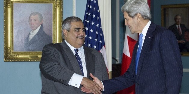 US Secretary of State John Kerry(R) and Bahrain's Foreign Affairs Minister Sheik Khaled bin Ahmed al-Khalifa shake hands afte