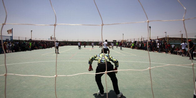 AL-AZRAQ, JORDAN - APRIL 30: Syrian refugees play soccer in the Al-Azraq camp for Syrian refugees on April 30, 2015 in Al-Azraq, Jordan. To celebrate the first anniversary of the camp's opening, UNHCR, Care and other partners innaugurated a multi-purpose sports ground, a souk in the market in Village 3, launced the 1st Azraq soccer cup, an open air cinema and other recreational activities for children and adults. The camp is located in the desert 110 km to the east of Amman and not far from the Syrian border (Photo by Jordan Pix/Getty Images)