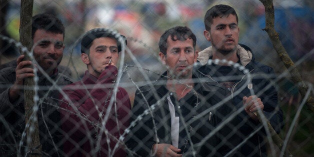 GEVGELIJA REFUGEE CAMP, GEVGELIJA, SOUTHEASTERN REGION, MACEDONIA - 2016/03/06: Migrants in the camp of Idomeni look beyond the barbed wire to Gevgelija on the border between Greece and Macedonia. Conditions of extreme difficulty at the Idomeni's camp where the population exceeded 10,000 is experienced. At the moment there are about 400 refugees crossing the border in the direction to Camp Gevgelija in Macedonia to continue their journey to North of Western Europe. (Photo by Ivan Romano/Pacific Press/LightRocket via Getty Images)