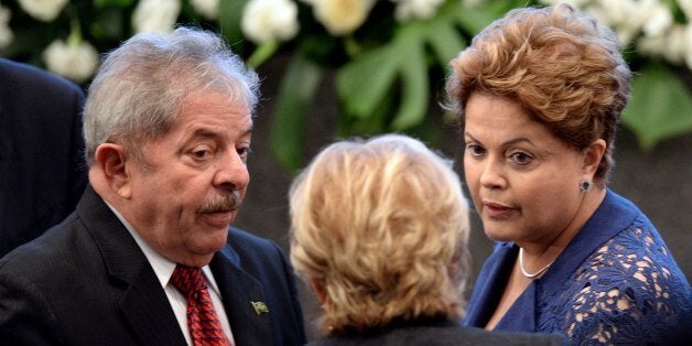 Brazilian President Dilma Rousseff (R) and former President Luiz Inacio Lula da Silva participate in the celebration for the 10th anniversary of the social welfare program Bolsa Familia (Family Allowance), in Brasilia, on October 30, 2013. The Family Allowance scheme was initiated by Rousseff's predecessor, Lula da Silva. AFP PHOTO / Evaristo Sa (Photo credit should read EVARISTO SA/AFP/Getty Images)