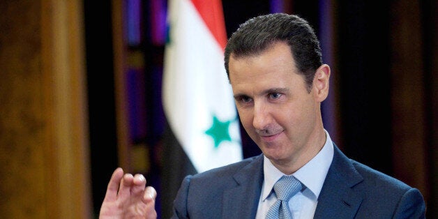 FILE - In this Feb. 10, 2015, file photo released by the Syrian official news agency SANA, Syrian President Bashar Assad give
