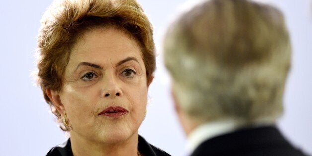 Brazilian President Dilma Rousseff (L) and her Vice President Michel Temer during the presentation ceremony of the new army generals at the Army Club in Brasilia, on December 16, 2015. Rousseff is fighting for her political life as she stands accused of illegal budgeting manoeuvres that she says were long-accepted practices by previous governments. AFP PHOTO/EVARISTO SA / AFP / EVARISTO SA (Photo credit should read EVARISTO SA/AFP/Getty Images)