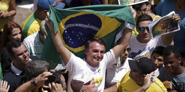 Congressman Jair Bolsonaro holds a Brazilian flag during a protest against Brazil's President Dilma Rousseff, part of nationwide protests calling for her impeachment, in Brasilia, Brazil, March 13, 2016. REUTERS/Ueslei Marcelino