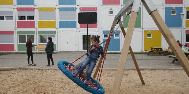 BERLIN, GERMANY - APRIL 14: Children play at the container settlement shelter for refugees and migrants in Zehlendorf district on April 14, 2016 in Berlin, Germany. Locals, many of them retirees, come to the shelter regularly to help the refugees and migrants, who are from countries including Syria, Iraq, Afghanistan, Kosovo and Serbia. The coalition partners of the German government have announced a new package of legislation that includes measures to foster the integration of refugees who have received asylum status in Germany. (Photo by Sean Gallup/Getty Images)