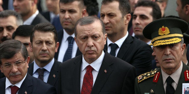 Turkey's President Recep Tayyip Erdogan, center, Prime Minister Ahmet Davutoglu, left, Chief of Staff Gen. Hulusi Akar, right, arrive to attend funeral prayers for army officer Seckin Cil, who was killed in Sur, Diyarbakir Wednesday, in Ankara, Turkey, Thursday, Feb. 18, 2016. Six soldiers were killed after PKK rebels detonated a bomb on the road linking the cities of Diyarbakir and Bingol in southeastern Turkey as their vehicle was passing by, according to Turkeyâs state-run Anadolu Agency. The deaths come a day after a suicide bombing claimed the lives of at least 28 people and wounded dozens of others.(AP Photo/Burhan Ozbilici)