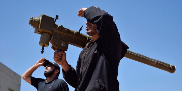 Rebel-fighters monitor the sky holding a FN-6 man-portable air-defence system (MANPADS) in the Syrian village of Teir Maalah, on the northern outskirts of Homs, on April 20, 2016. / AFP / MAHMOUD TAHA (Photo credit should read MAHMOUD TAHA/AFP/Getty Images)