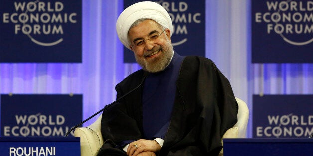 Iran's President Hassan Rouhani smiles during a session at the annual meeting of the World Economic Forum (WEF) in Davos January 23, 2014. REUTERS/Ruben Sprich (SWITZERLAND - Tags: POLITICS BUSINESS TPX IMAGES OF THE DAY) 