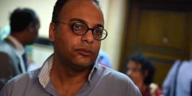 Renowned human rights activist Hossam Bahgat looks on as an Egyptian court examines a request to issue a travel ban and freez