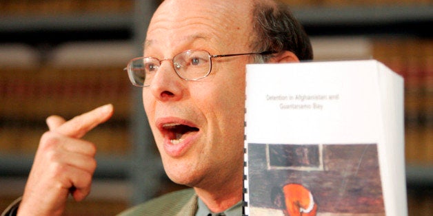 Michael Ratner, President of the Center for Constitutional Rights, holds a copy of a report on conditions at the Guantanamo Bay detention facility at a press conference in New York, August 4, 2004. Three Britons released from Guantanamo allege systematic abuse at the facility in the report. REUTERS/Peter Morgan PM/GN