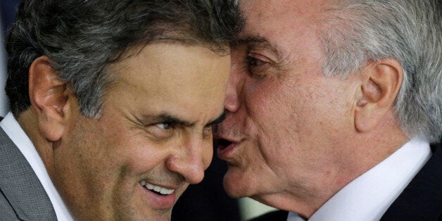 Brazil's interim President Michel Temer (R) talks with Senator Aecio Neves during a ceremony where he made his first public r