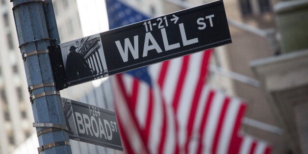 A Wall Street street sign is displayed in front of the New York Stock Exchange (NYSE) in New York, U.S., on Monday, April 18,