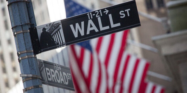 A Wall Street street sign is displayed in front of the New York Stock Exchange (NYSE) in New York, U.S., on Monday, April 18, 2016. U.S. stocks advanced after erasing an early decline, as investors shook off oil's losses on failed output talks and looked toward this week's bevy of corporate earnings. Photographer: Michael Nagle/Bloomberg via Getty Images