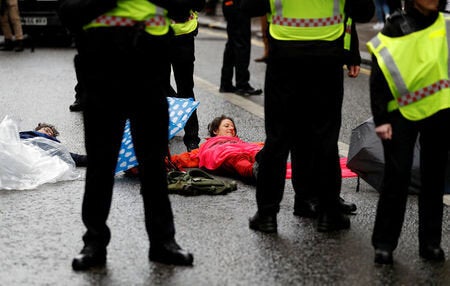 Demonstrators lie on the road, creating a blockade in the City of London