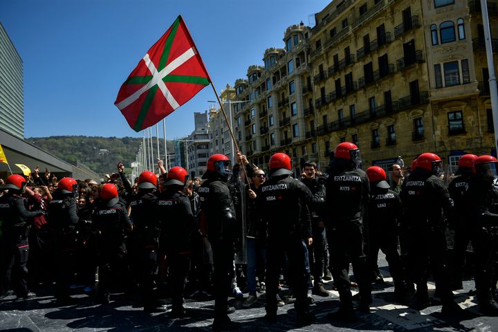 Basques pro-independence supporters hold Ikurrina (Basque flags and Catalonia independence flag known as ''estelada'') flags as they clash with riot police.