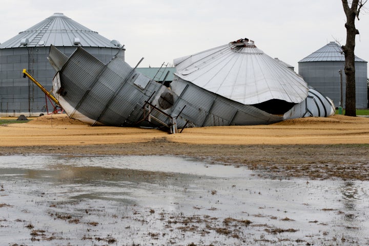 In this April 10, 2019 photo, flood waters from the Missouri River destroyed grain silos and washed soybeans out of them, on a farm in Bellevue, Neb. 