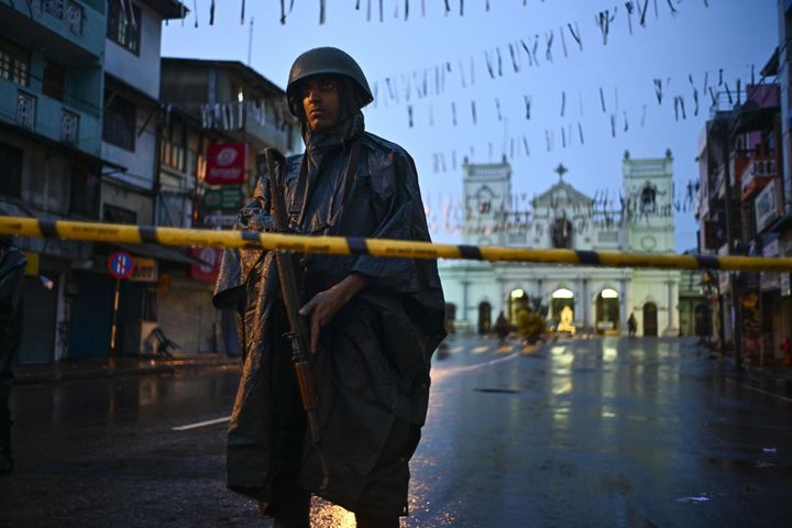 A Sri Lankan soldier stands guard under the rain at St. Anthony's Shrine in Colombo on April 25, 2019, following a series of bomb blasts targeting churches and luxury hotels on the Easter Sunday in Sri Lanka.
