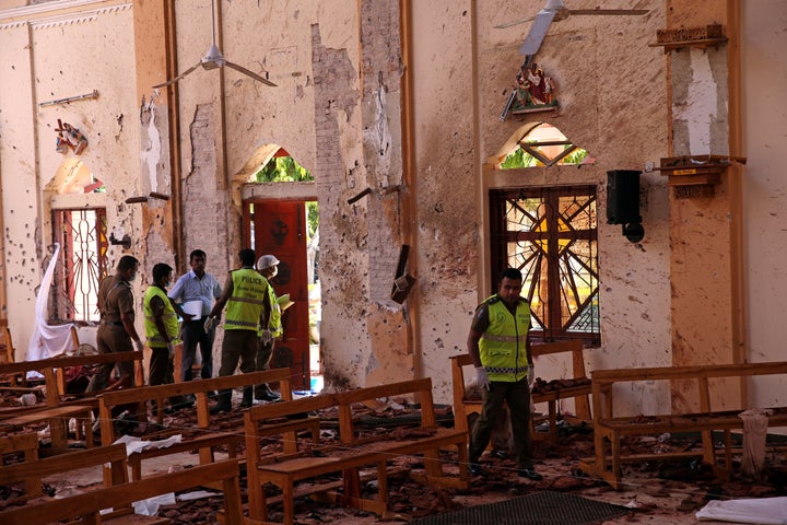 Police officers work at the scene at St. Sebastian Catholic Church, after bomb blasts ripped through churches and luxury hotels on Easter, in Negombo, Sri Lanka April 22, 2019.
