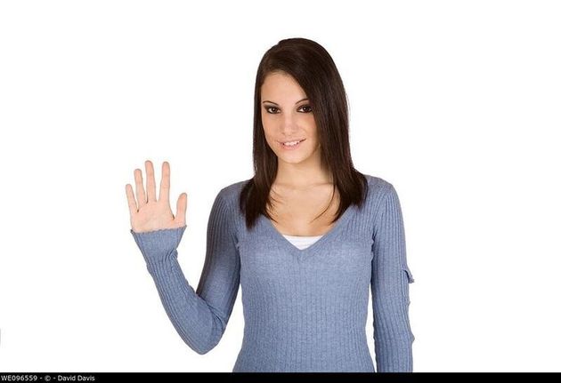 Beautiful Caucasian teenager counting on fingers on green