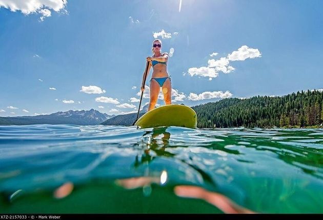 touring on the Stand Up Paddle Board at Redfish Lake in the Sawtooth Mountains near the town of Stanely...