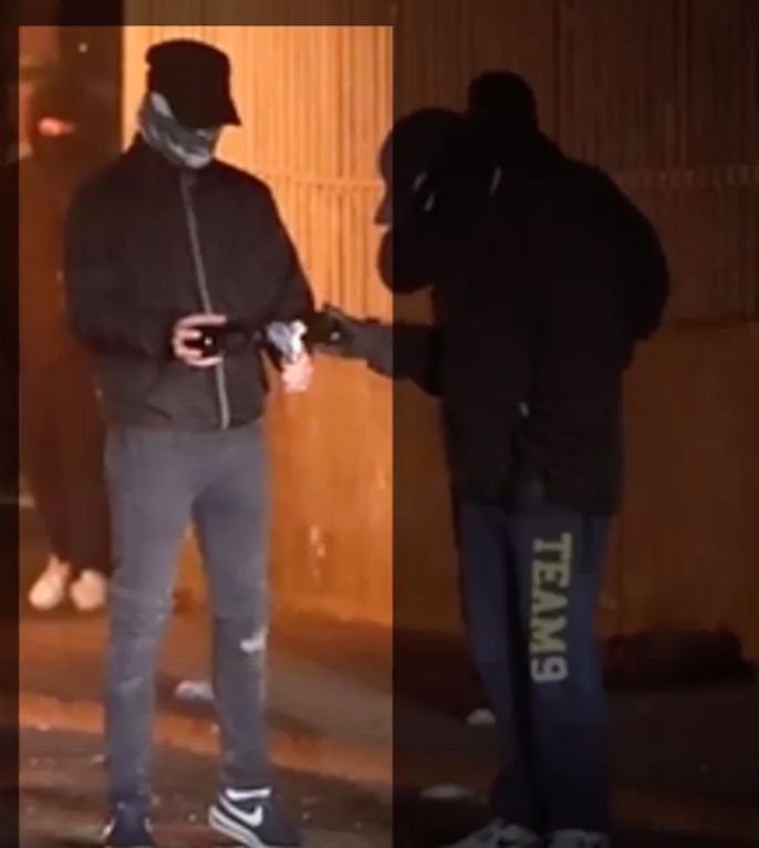 A suspect holding a petrol bomb who was also pictured earlier in the sequence 