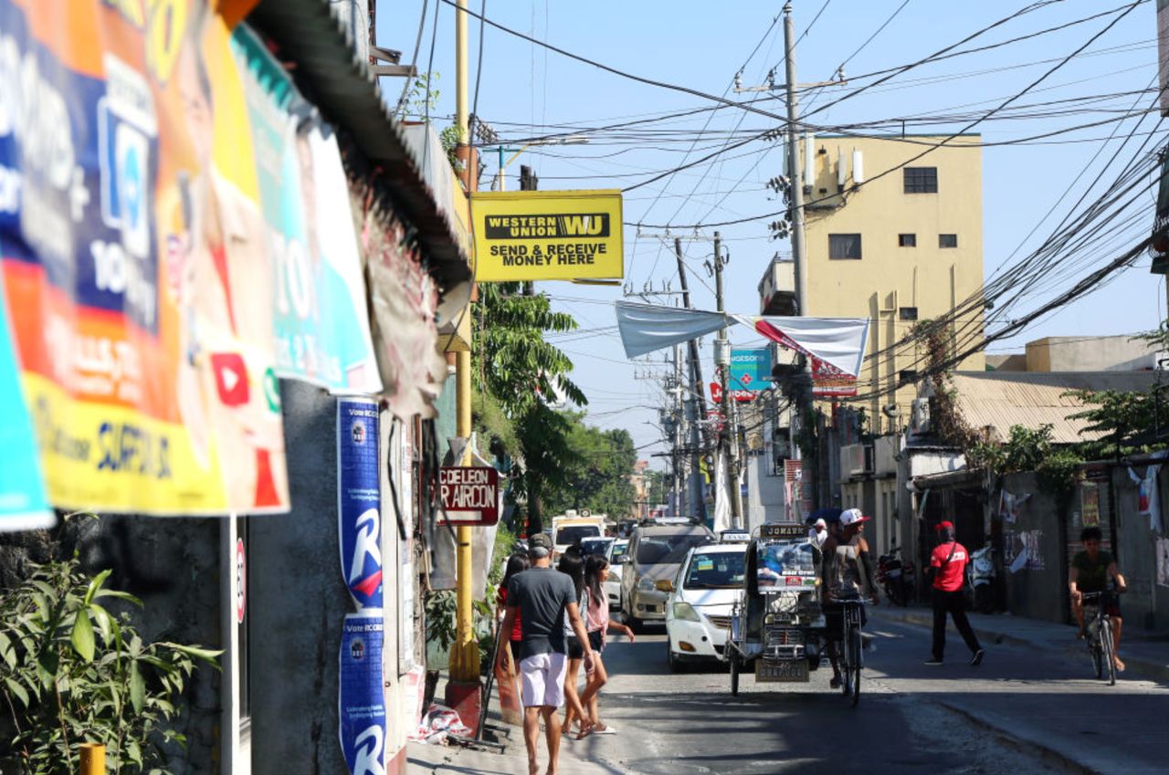 Filipinos abroad routinely send money home through money transfer companies like Western Union, seen here in a low-income community of Manila.