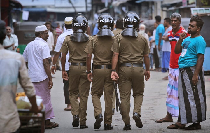 Sri Lankan policeman patrol in a Muslim neighborhood before Friday prayers in Colombo, Sri Lanka, on Friday.