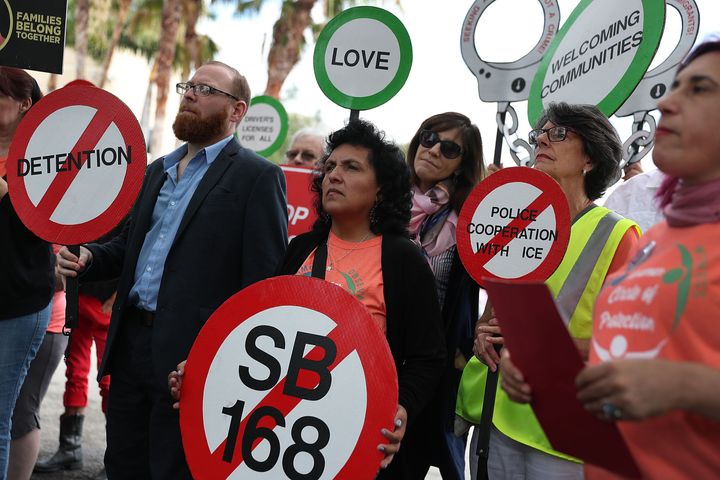 Immigrant rights activists in Miramar, Florida, held signs protesting the "anti-sanctuary" bills moving through the Florida Legislature on April 10.