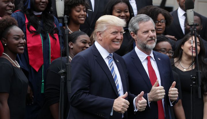 President Donald Trump and Jerry Falwell Jr., president of Liberty University, with members of a gospel choir during a May 13, 2017, commencement in Lynchburg, Virginia.