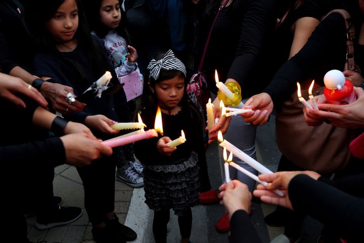 A girl among people during a vigil, outside of the presidential palace in Nicosia, Cyprus, on Friday.