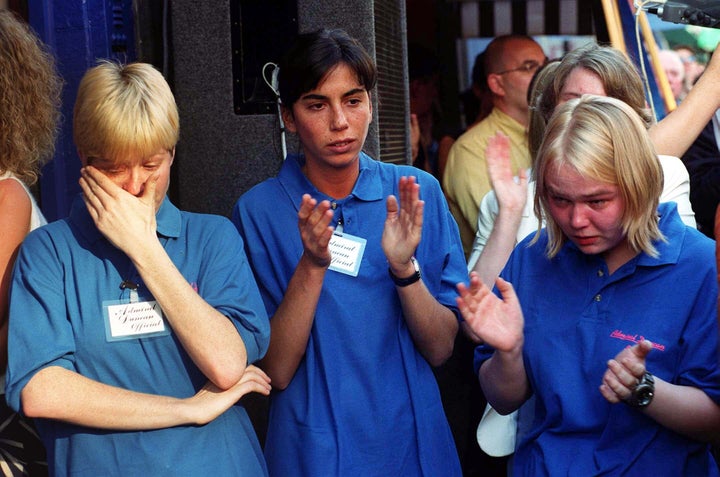 Staff celebrate the reopening of the Admiral Duncan pub in Soho, central London, nine weeks after it was devastated by a nail bomb attack.