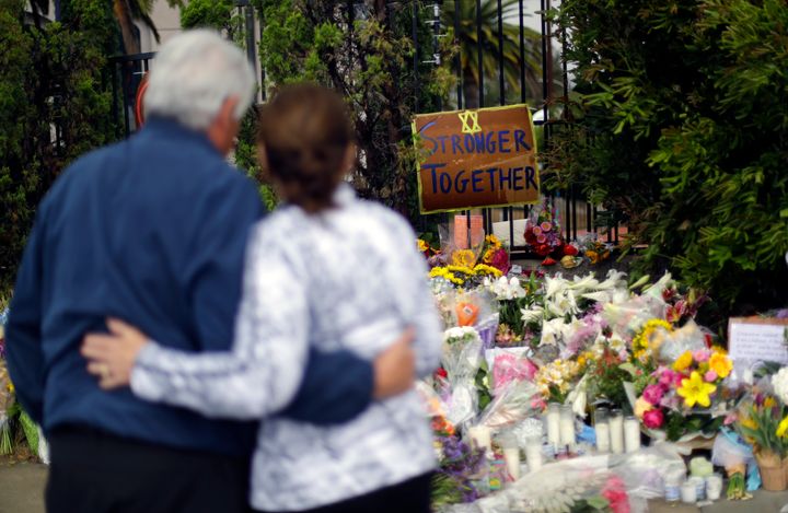 Two people embrace near a memorial across the street from the Chabad of Poway synagogue in Poway, California, on April 29, 20