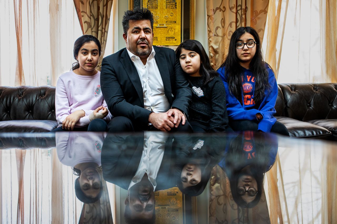 Omarkheil and his daughters in their home. He is worried he might have to sell his home if he doesn’t find work soon.