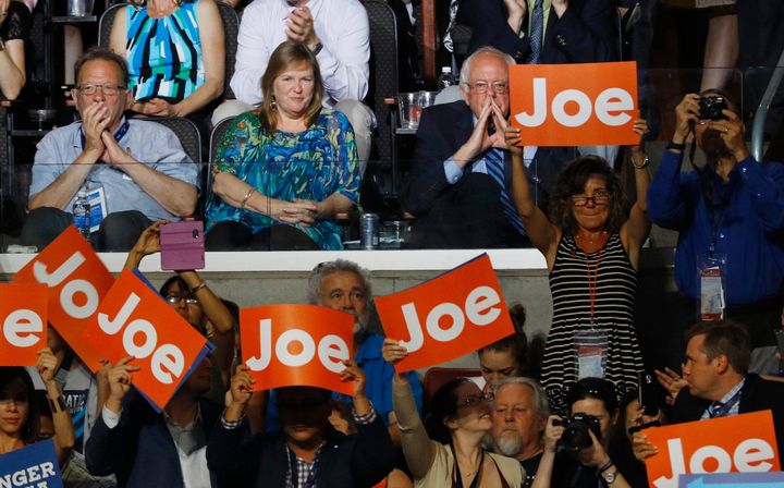 Sen. Bernie Sanders listens to a speech from then-Vice President Joe Biden at the 2016 Democratic National Convention.