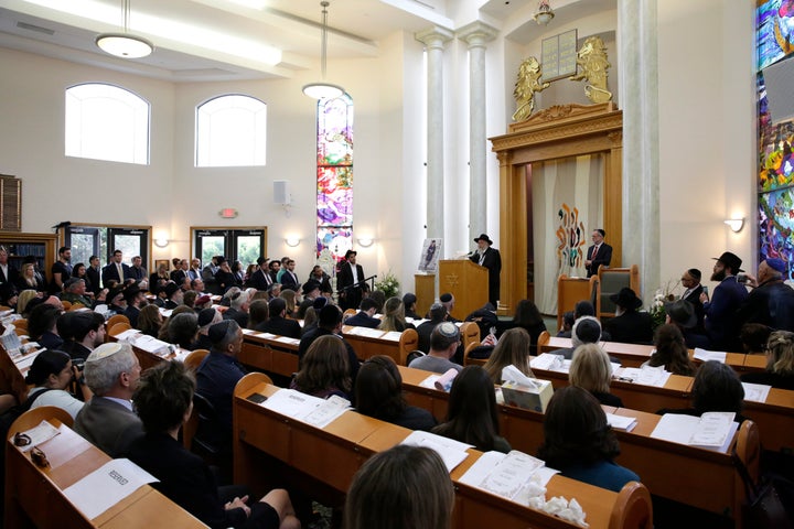 Yishoel Goldstein, center, Rabbi of Chabad of Poway, speaks on April 29, 2019, during a memorial service for Lori Kaye, in Po