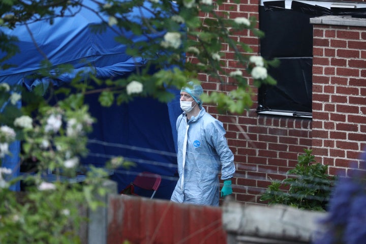 Forensic investigators at the property where the bodies were found