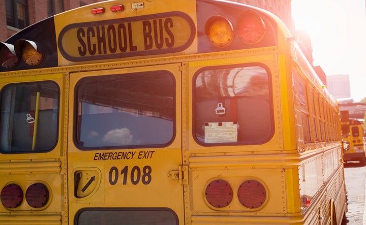 Stock photo of the back of a yellow school bus. 