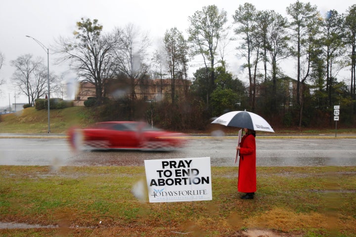 A protester stands near the West Alabama Women’s Center in Tuscaloosa, Alabama, in 2016.