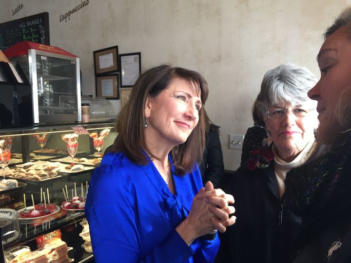 Marie Newman, left, speaks with supporters at a campaign event in Feb. 2018. The Democratic Party has tried to undercut her second bid, but she shows signs of resilience.