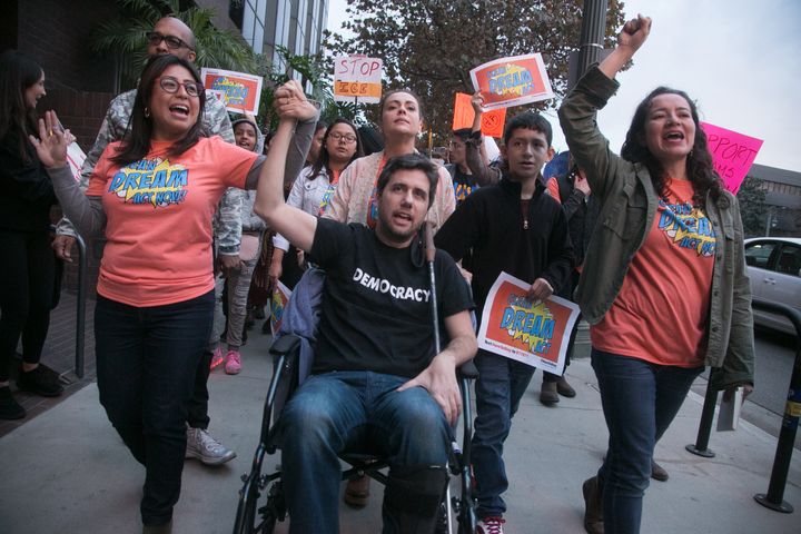 Ady Barkan (center) attends the Los Angeles Supports a Dream Act Now! protest with actress Alyssa Milano and others at the office of California Sen. Dianne Feinstein in January 2018 in Los Angeles. Tuesday, he testified about "Medicare for All" on Capitol Hill.