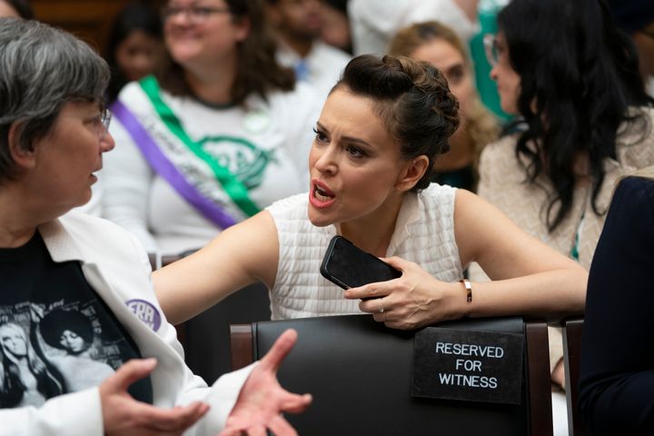 Jessica Neuwirth (left), president of the ERA Coalition, speaks with actress and activist Alyssa Milano at Tuesday's hearing.