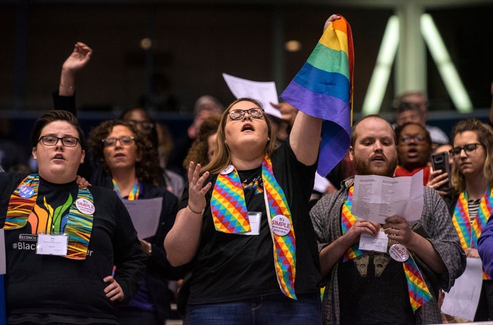 Protesters react after delegates to a United Methodist Church conference move to strengthen bans on same-sex marriage an