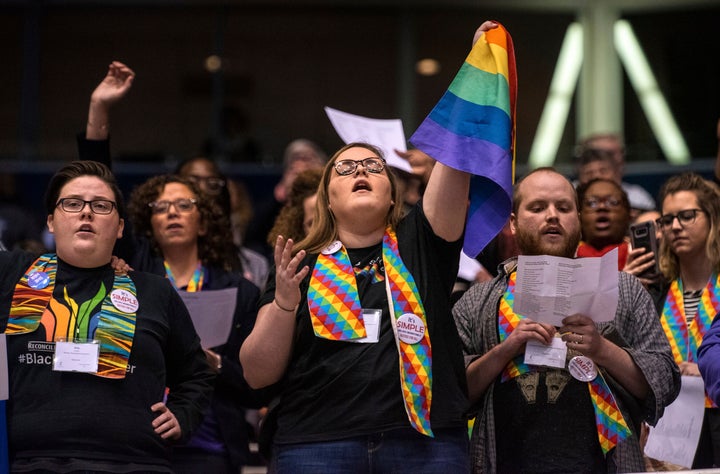 Protesters react after delegates to a United Methodist Church conference move to strengthen bans on same-sex marriage and the ordination of LGBT clergy, in St. Louis, Tuesday, Feb. 26, 2019.