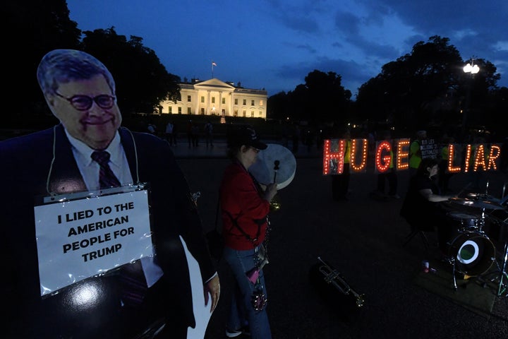Protesters at the White House on Tuesday night before Attorney General William Barr's scheduled appearance before the Senate