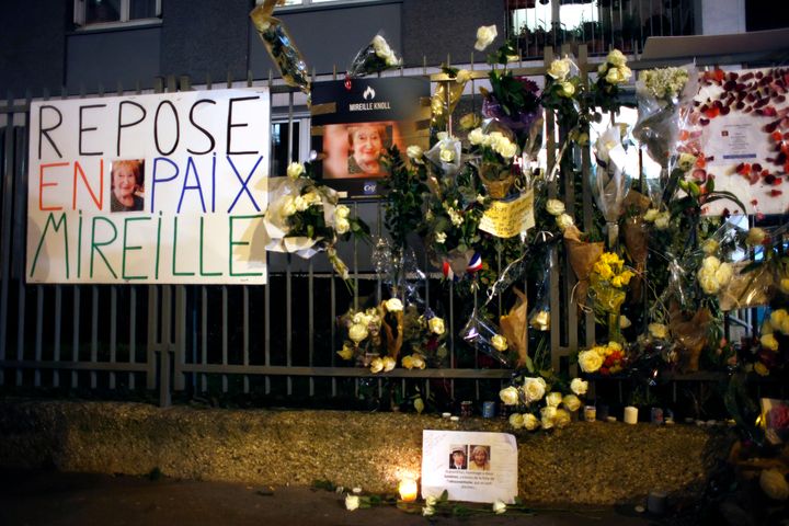 Flowers and placards outside Mireille Knoll's apartment during a silent march in Paris on March 28, 2018. The 85-year-old wom